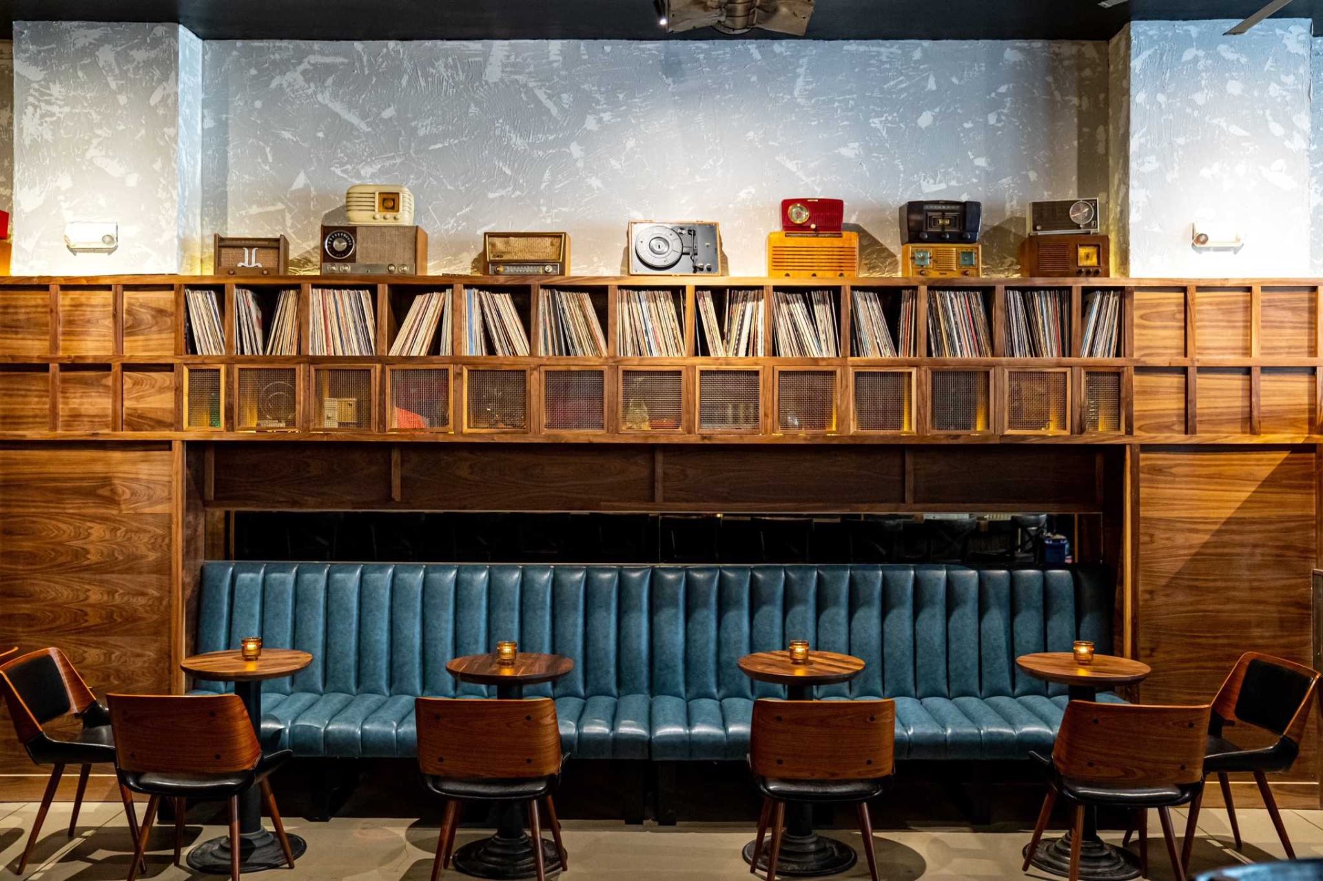 Harlan Records blue banquette and vintage vinyl shelving