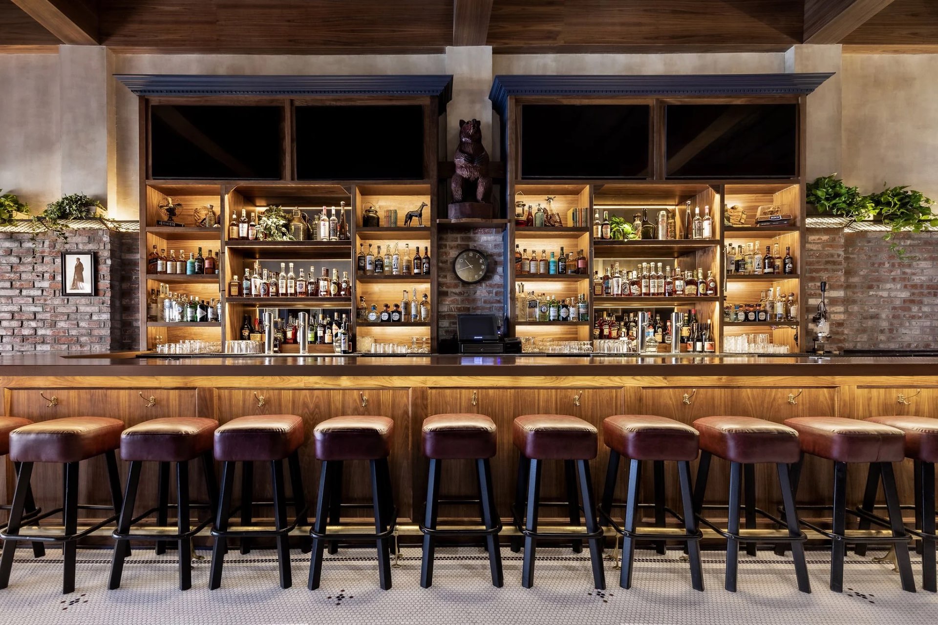 Yerba Buena Bar interior with wooden shelving and brick accents