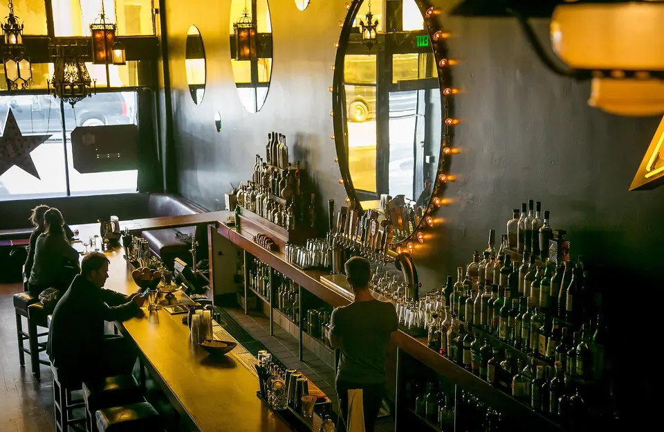 Tequila Mockingbird long wooden bar with warm backlighting