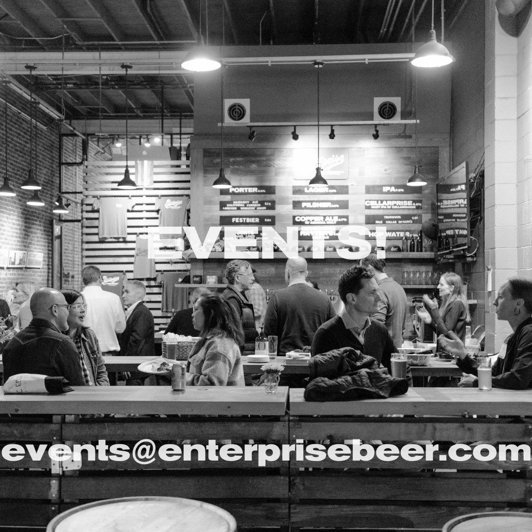 Enterprise Brewing taproom interior with long tables and guests